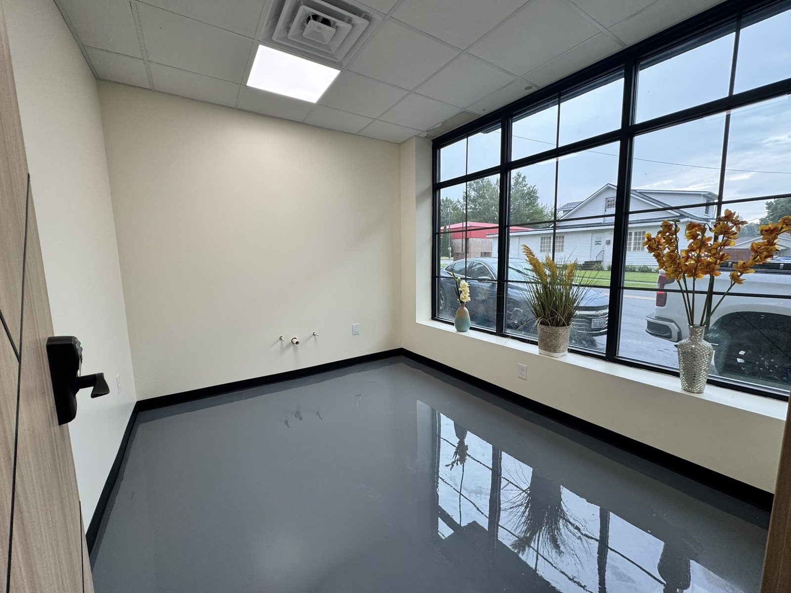 Private suite with a wall of windows facing the street